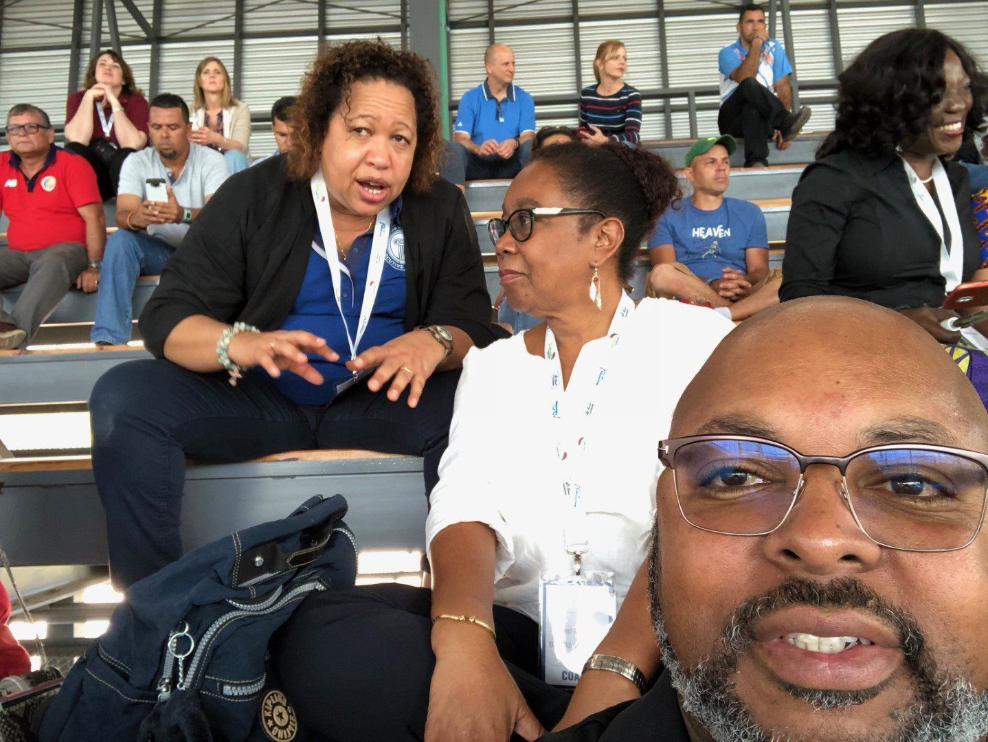 A group of people are sitting in a stadium watching a game