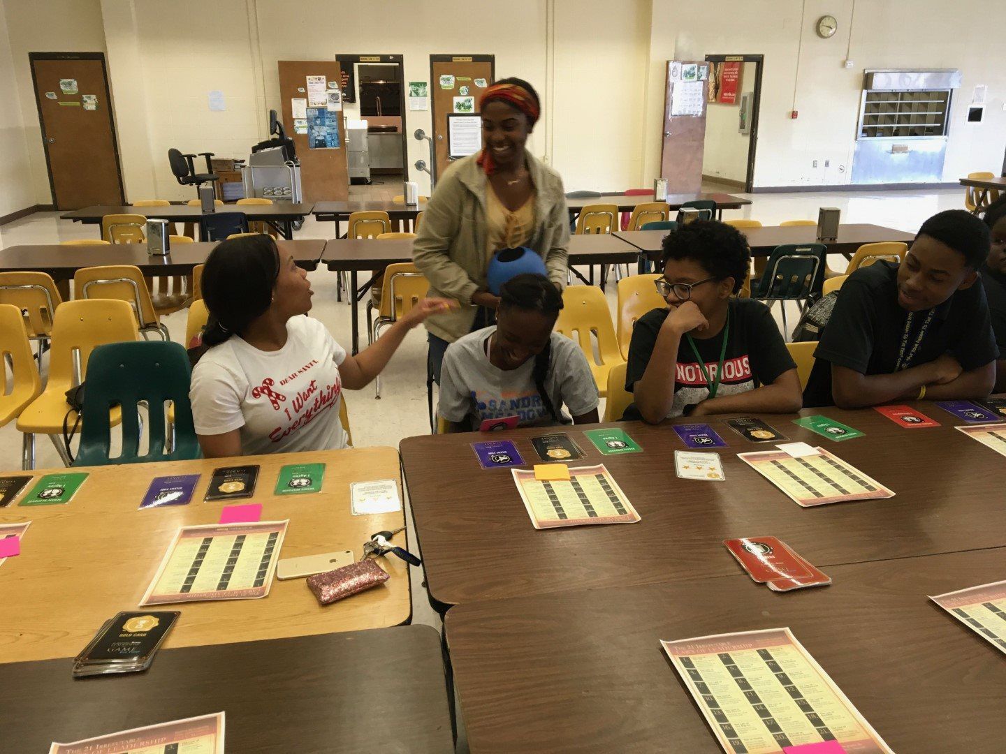 A group of people are sitting around a table with cards on it