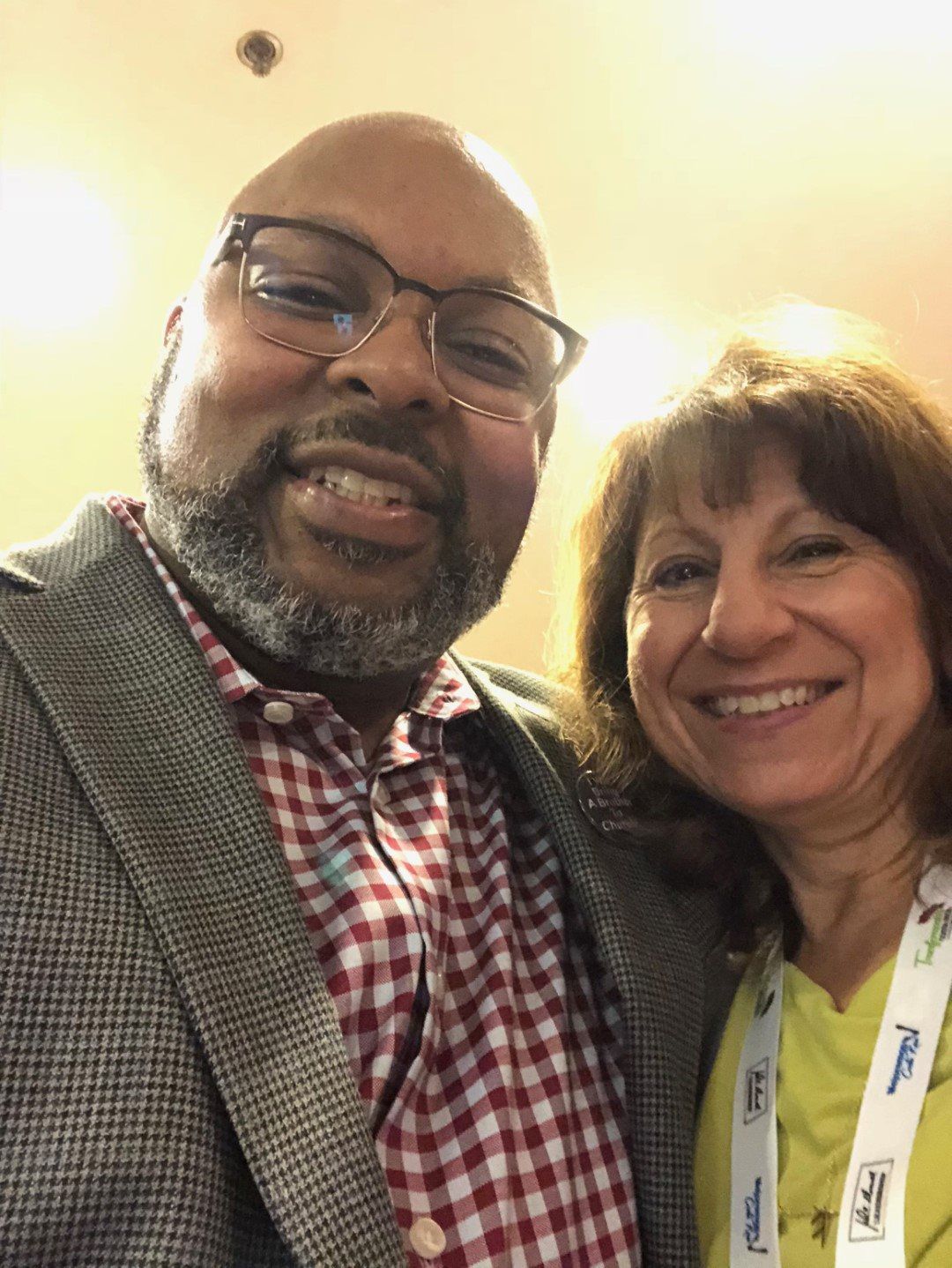 A man and a woman are posing for a picture together and smiling.