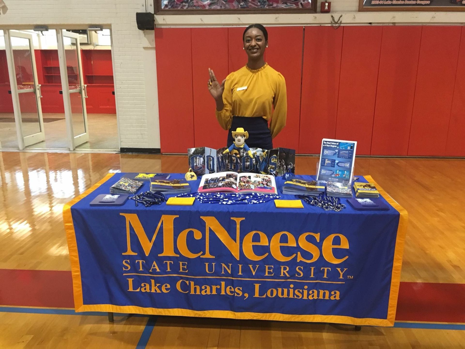 A woman is standing in front of a mcneese state university table