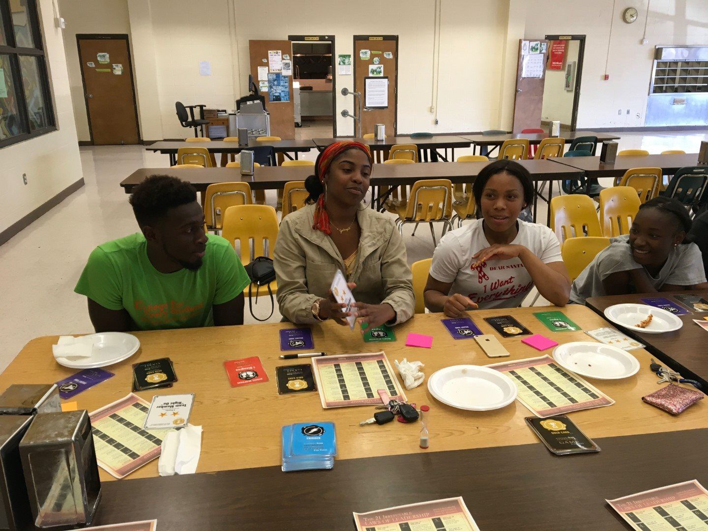 A group of people are sitting at a table playing a game.
