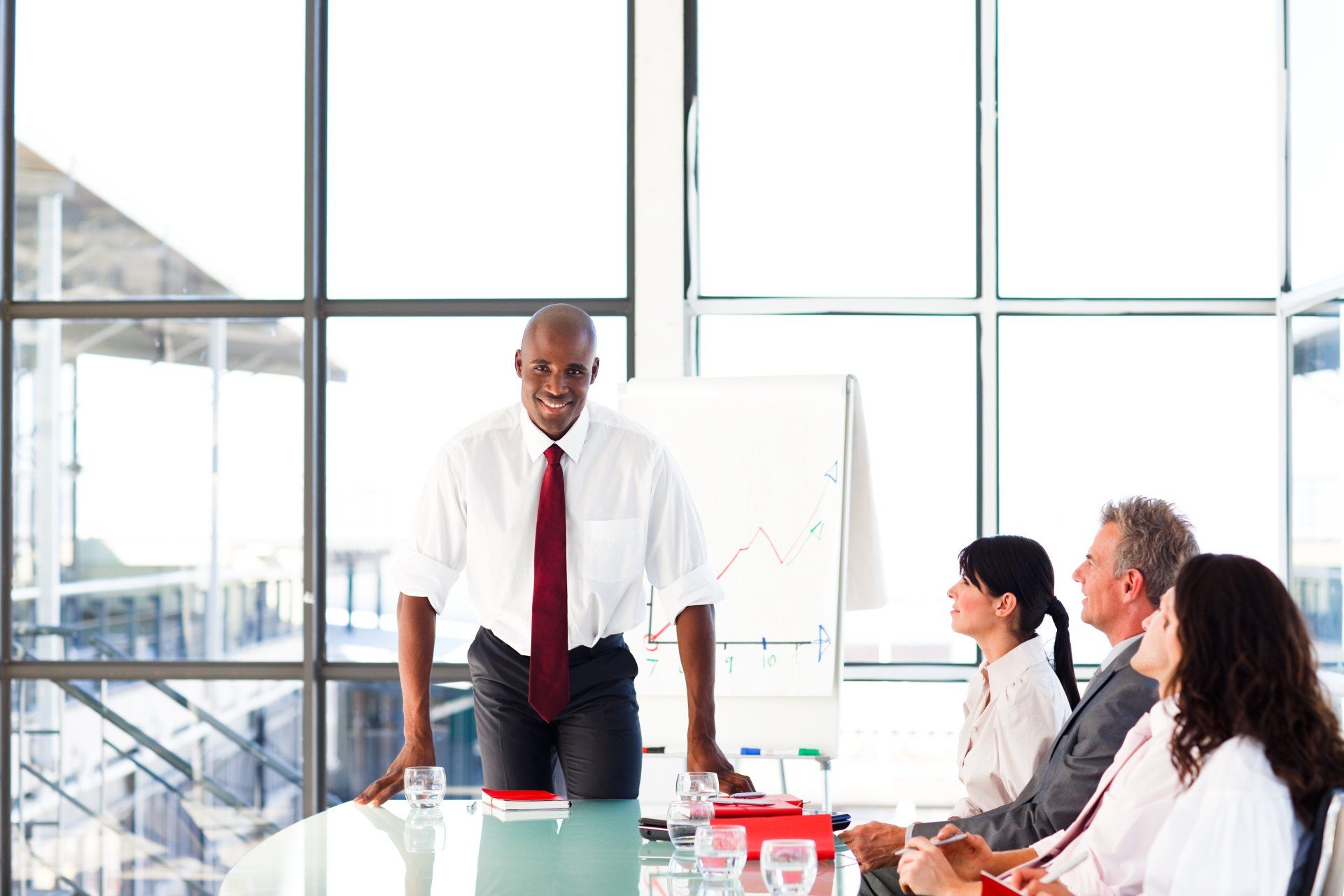 A man is giving a presentation to a group of people in a conference room.