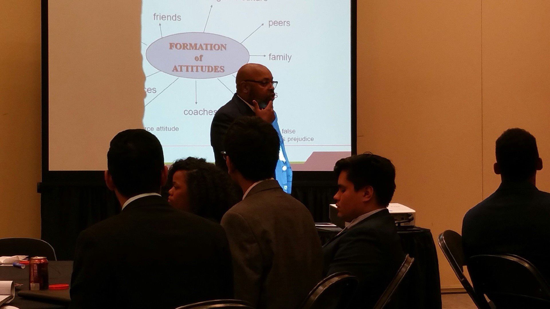 A man is giving a presentation to a group of people