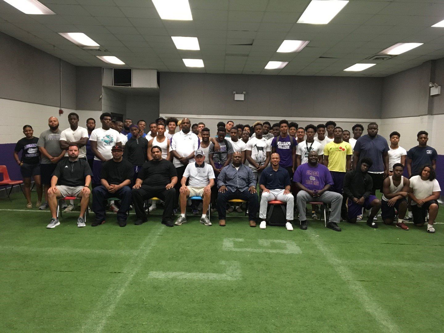 A group of people are posing for a picture in a room.