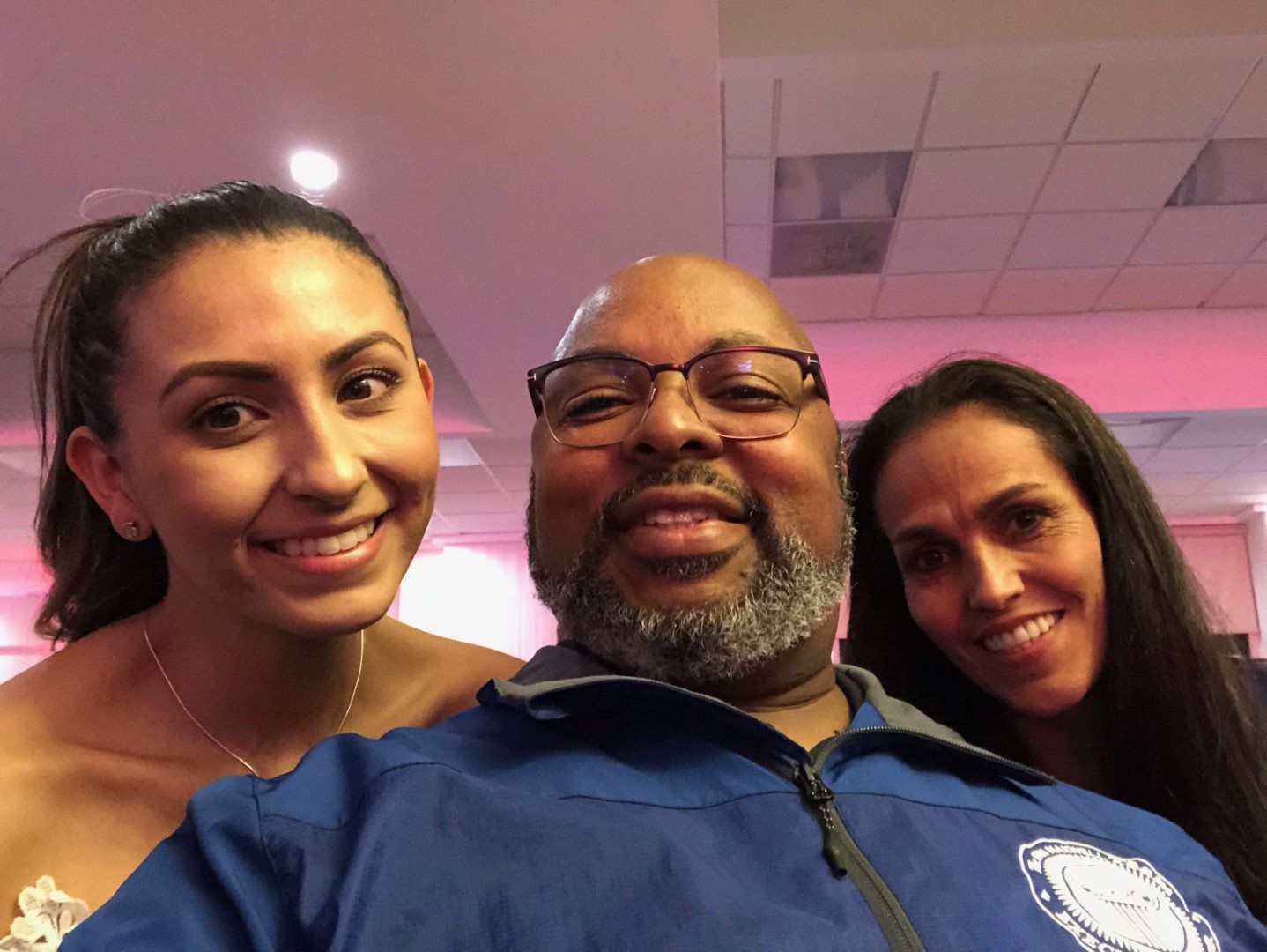 A man and two women are posing for a picture together