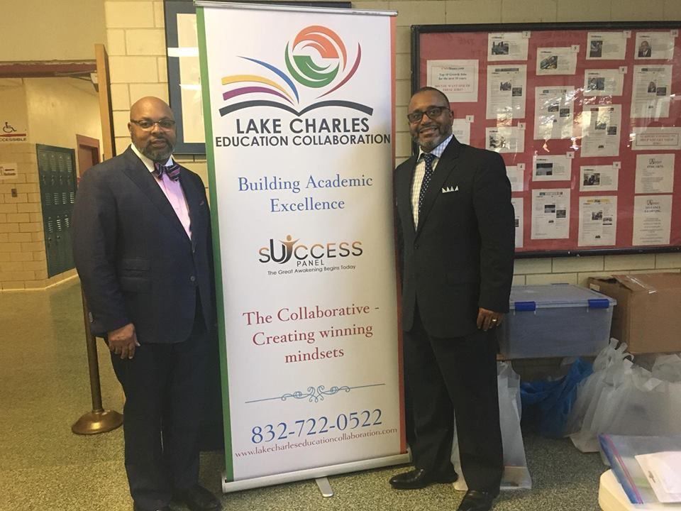 Two men are standing next to a sign that says lake charles education collaboration
