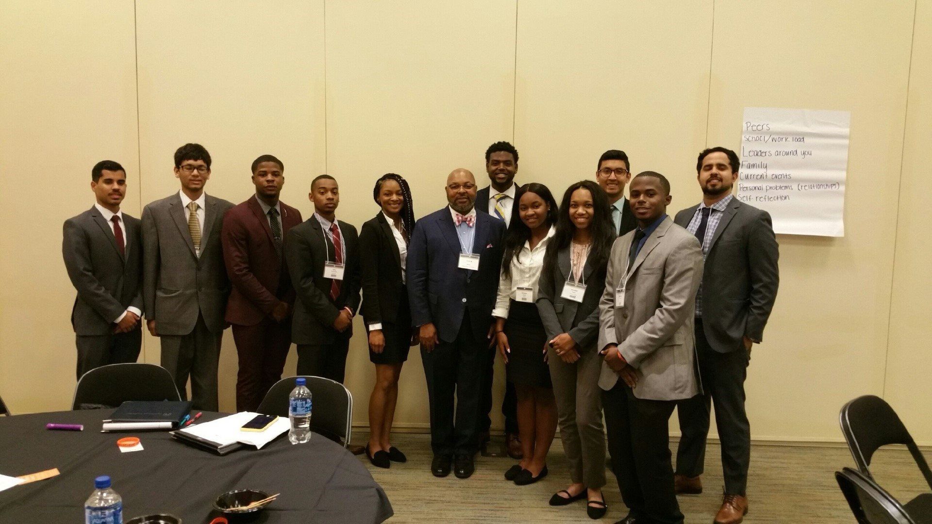 A group of people are posing for a picture in a room.