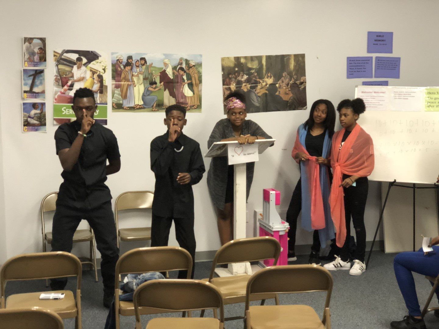 A group of people standing around a podium in a room