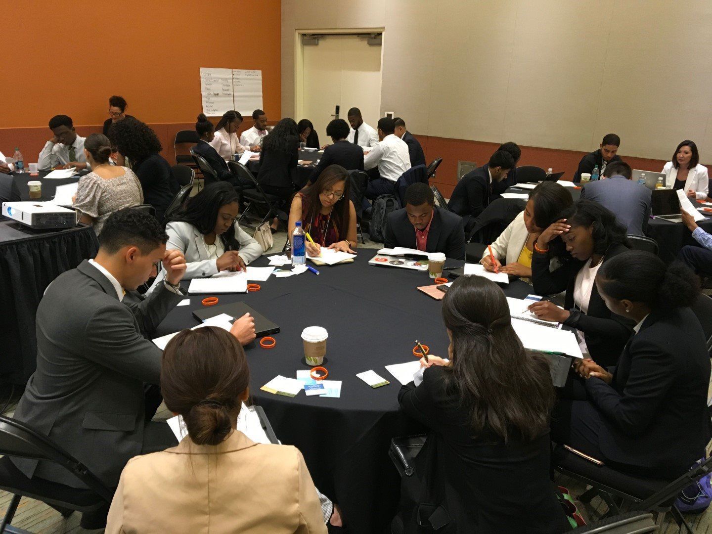 A group of people are sitting around a table in a room.