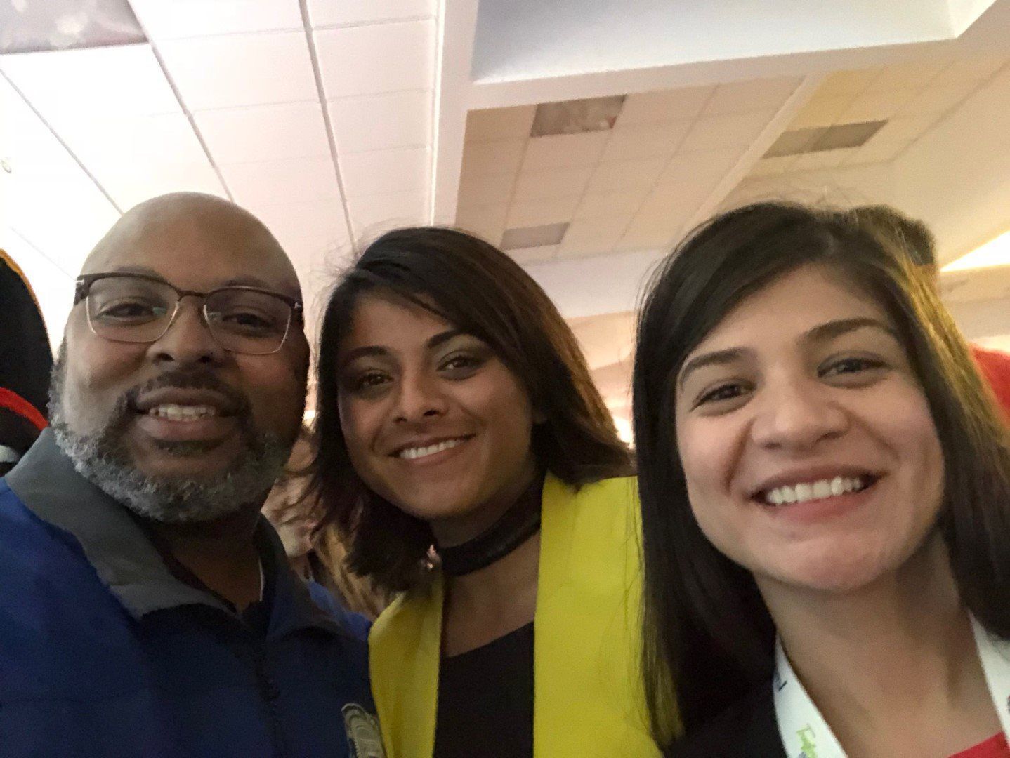 A man and two women are posing for a picture together