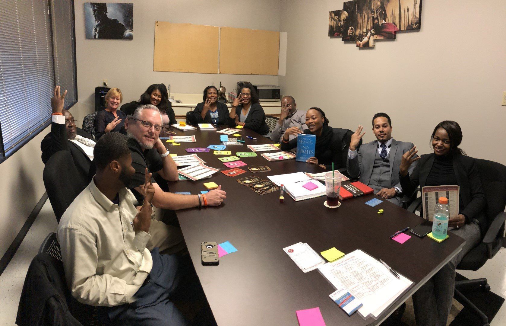 A group of people are sitting around a table with sticky notes on it.