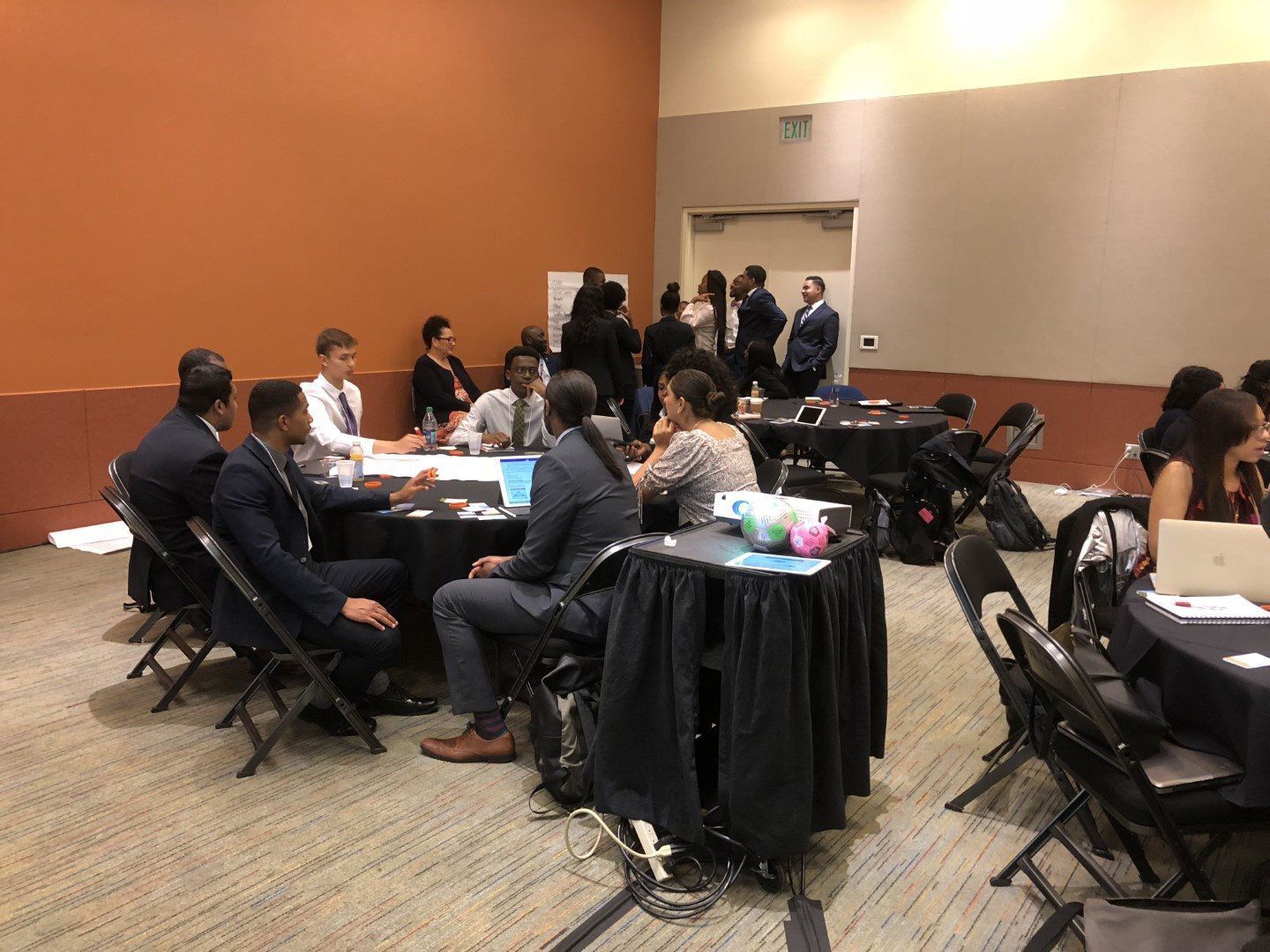 A group of people are sitting at tables in a room.