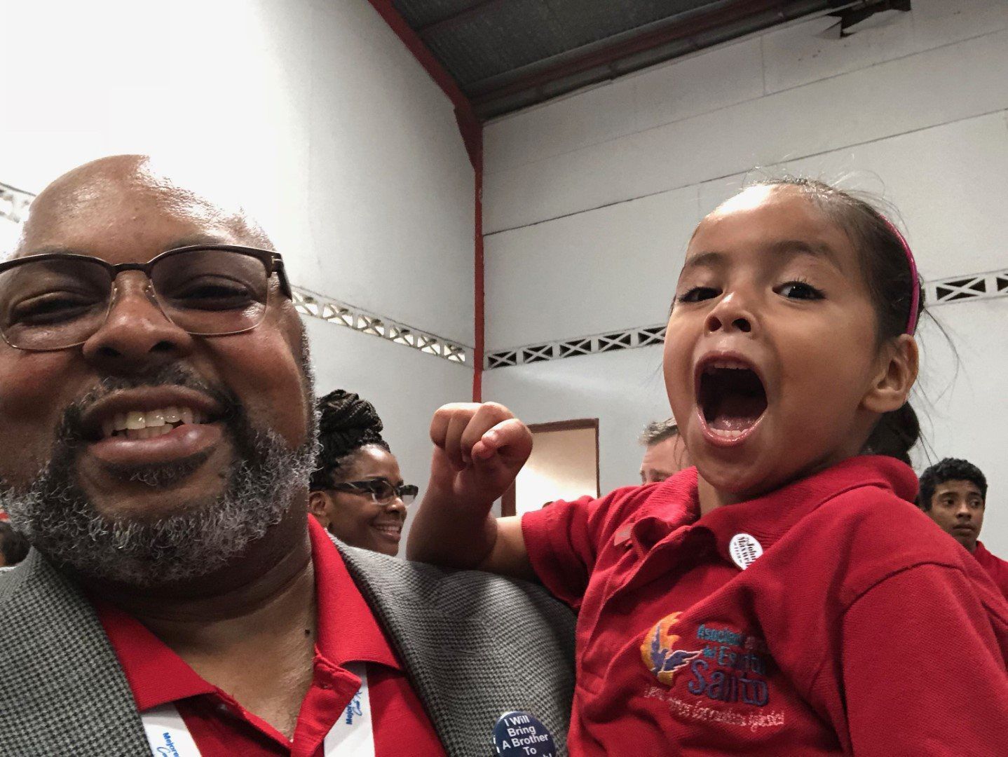 A man is holding a little girl in his arms.