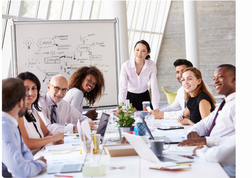 A group of people are sitting around a table having a meeting.