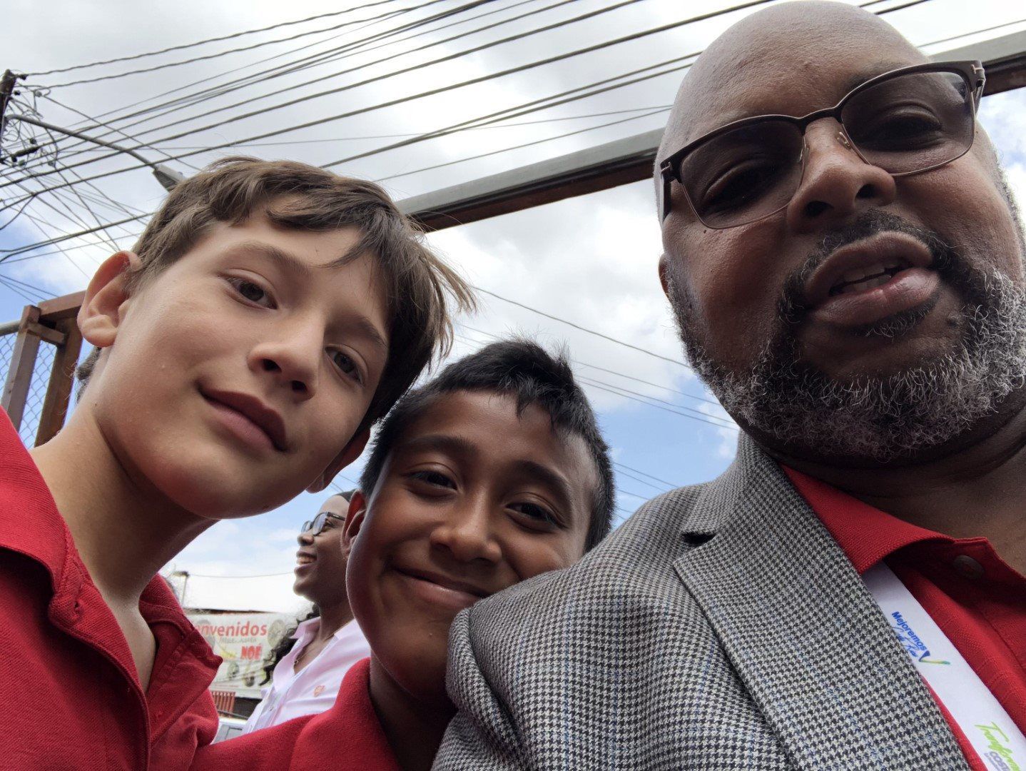 A man and two young boys are posing for a picture