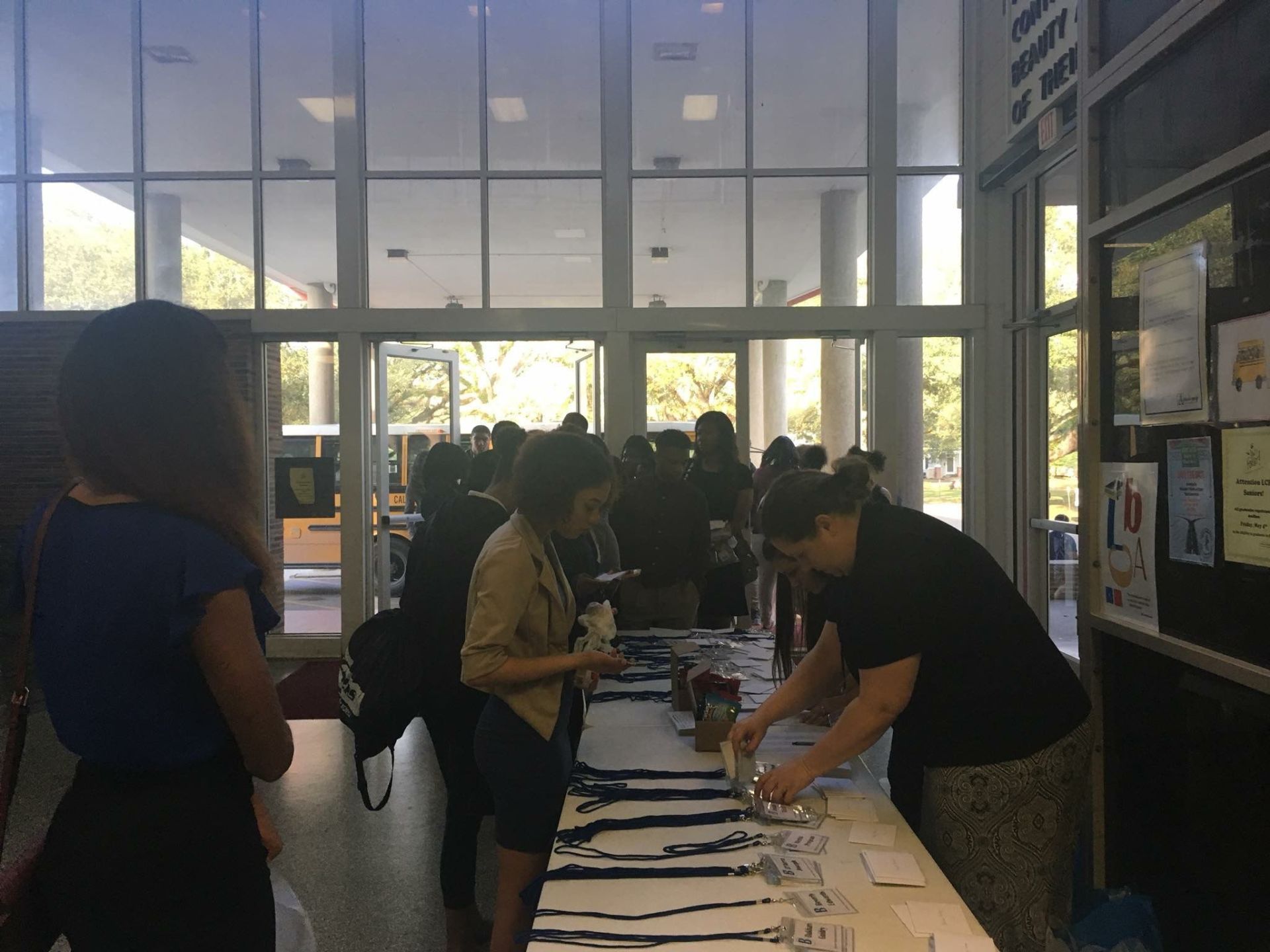 A group of people are standing around a table in a building.
