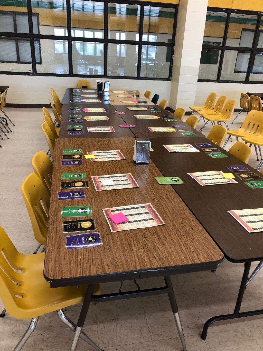 A long table with yellow chairs in a classroom
