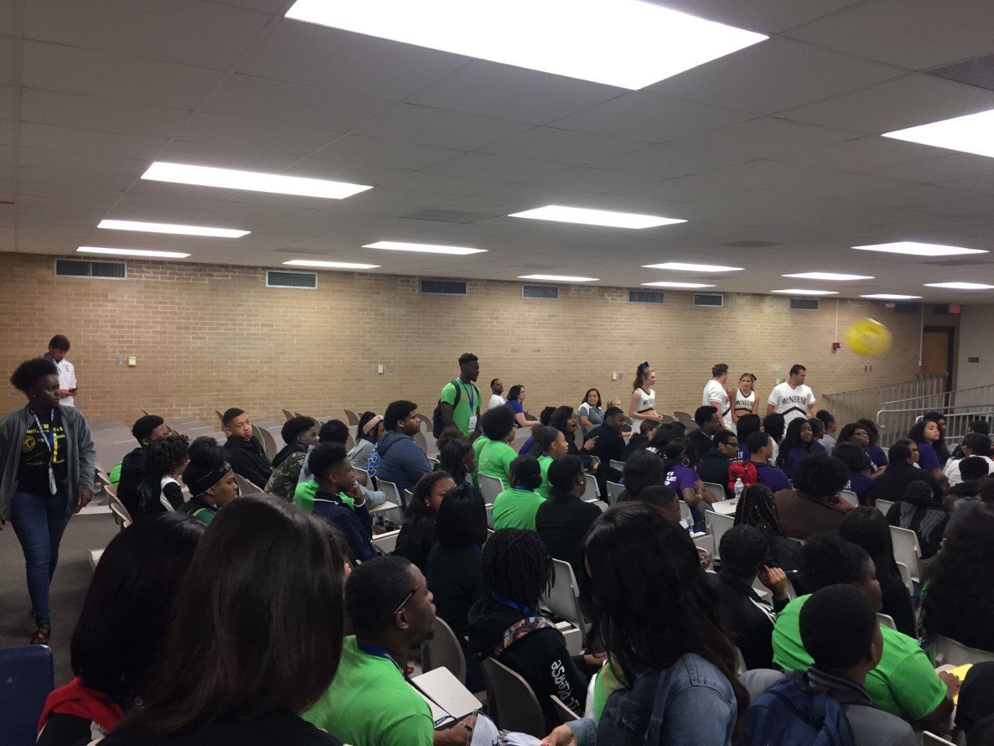 A large group of people are sitting in a room.