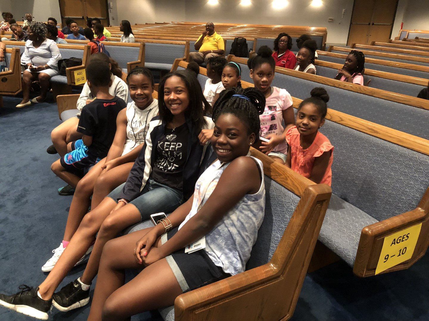 A group of children are sitting in a church.