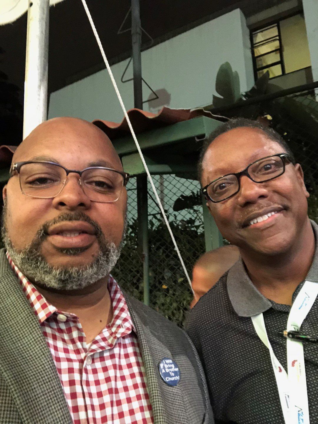 Two men are posing for a picture and one of them has a badge that says i-fi