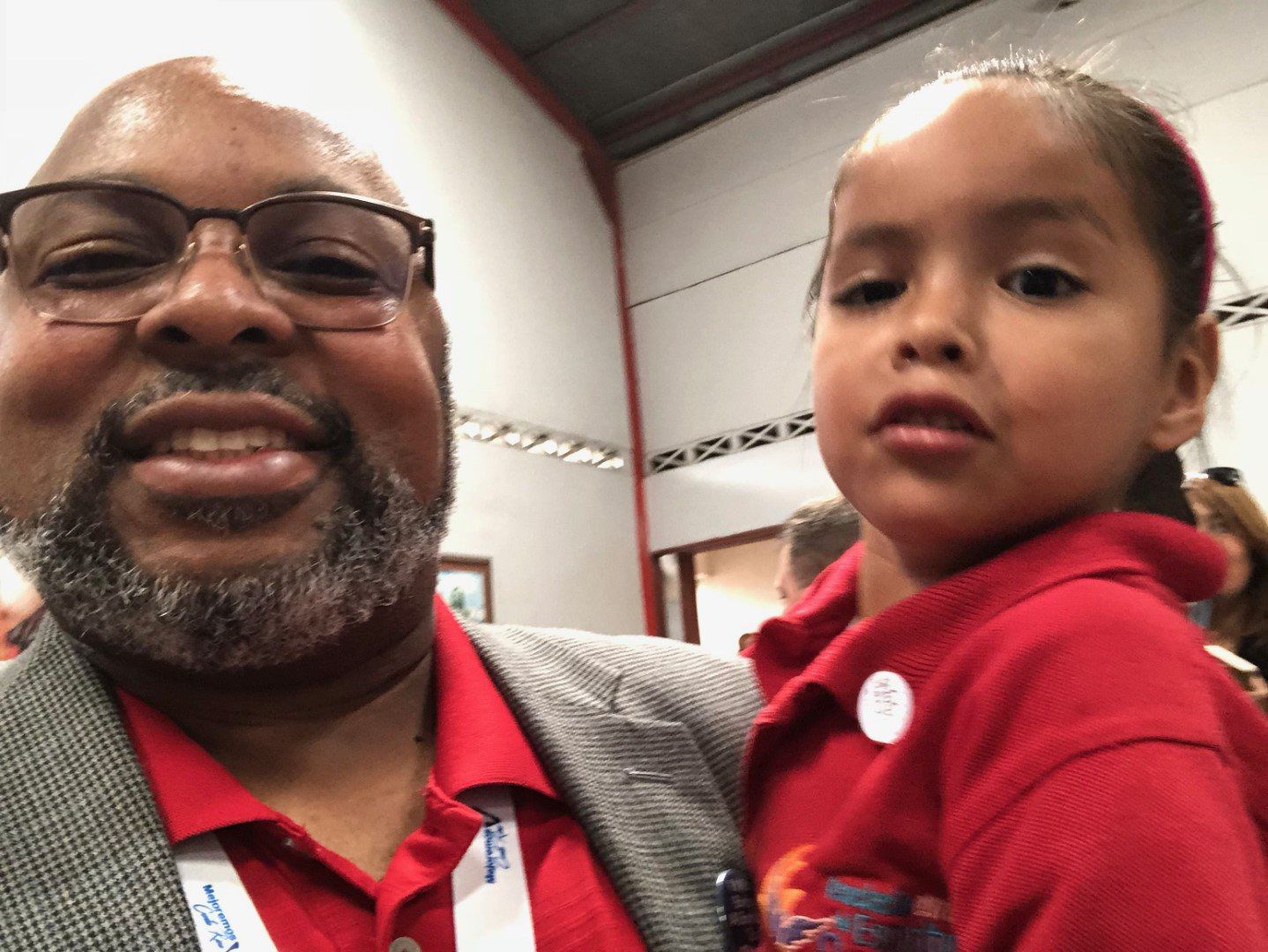 A man is holding a little girl in his arms