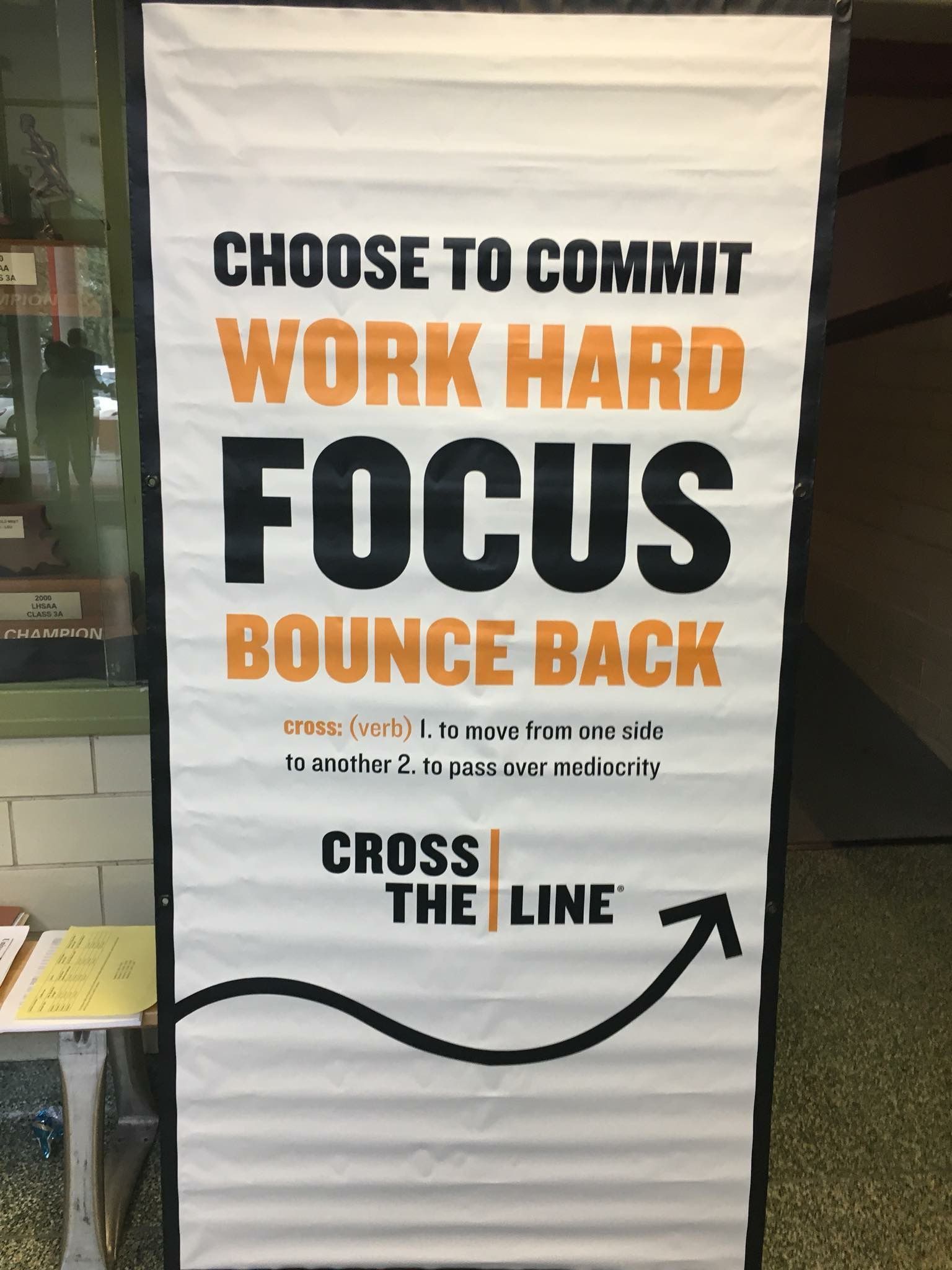 A sign that says choose to commit work hard focus bounce back cross the line