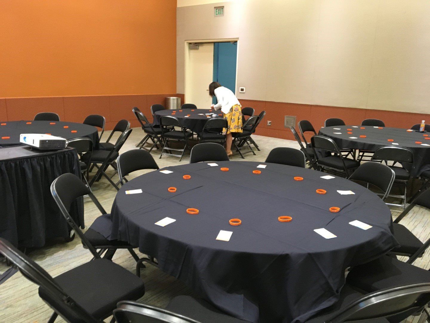 A room with tables and chairs set up for a party.