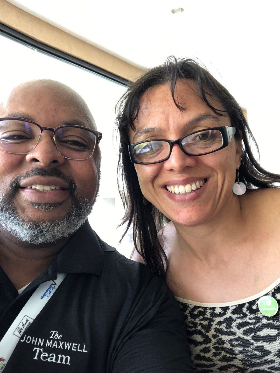 A man and a woman are posing for a picture together and smiling.