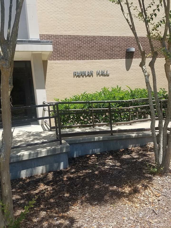 A brick building with a sign that says ' garriar hall ' on it