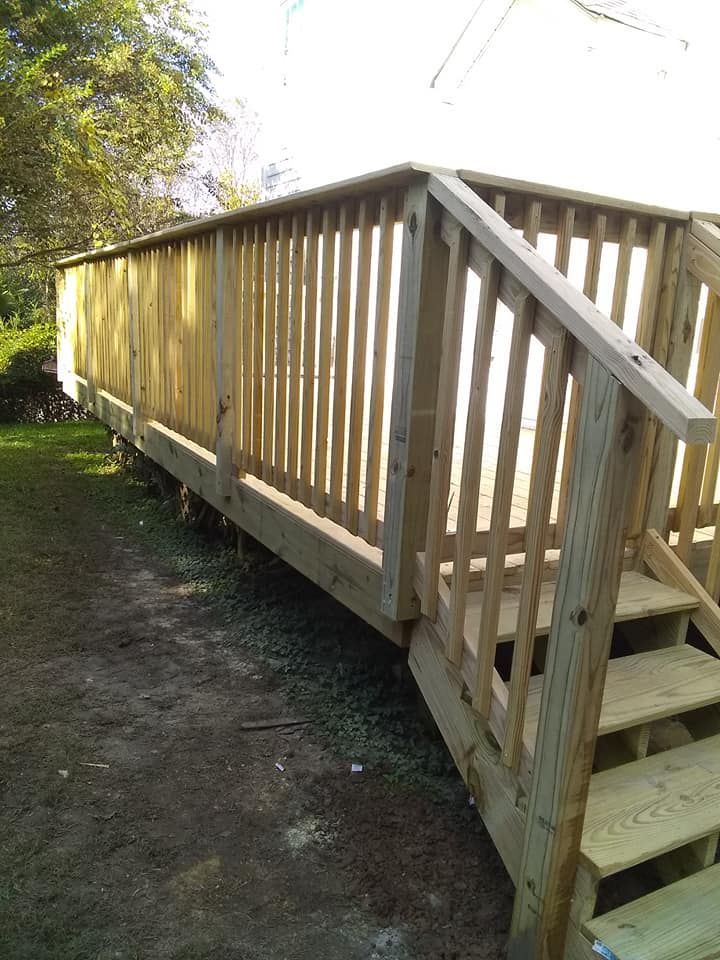 A wooden deck with stairs leading up to it
