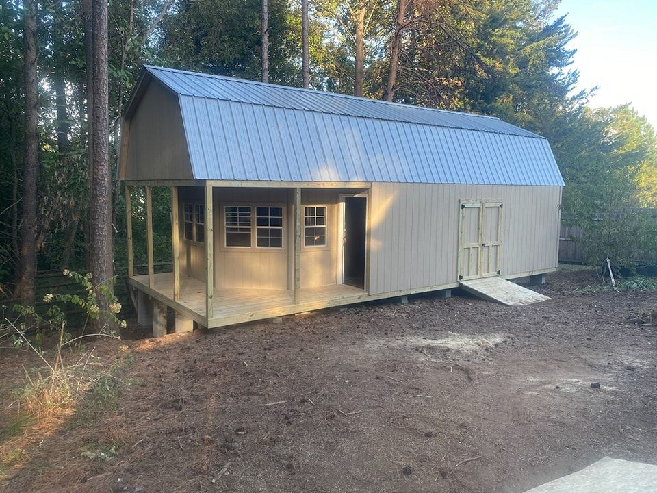 A barn with a porch and a metal roof