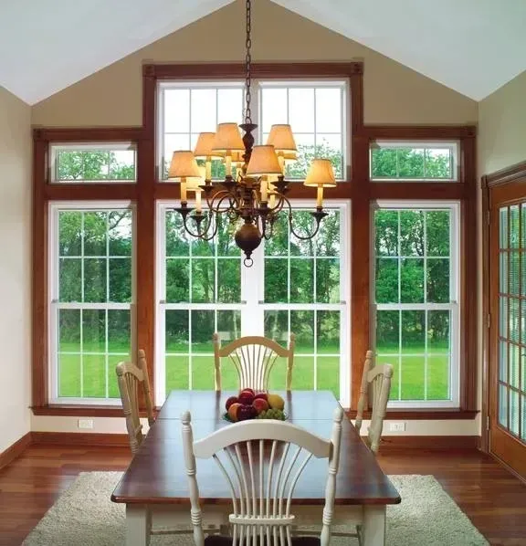 A dining room with a table and chairs and a chandelier
