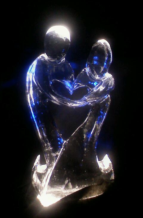 A statue of a man and woman hugging each other