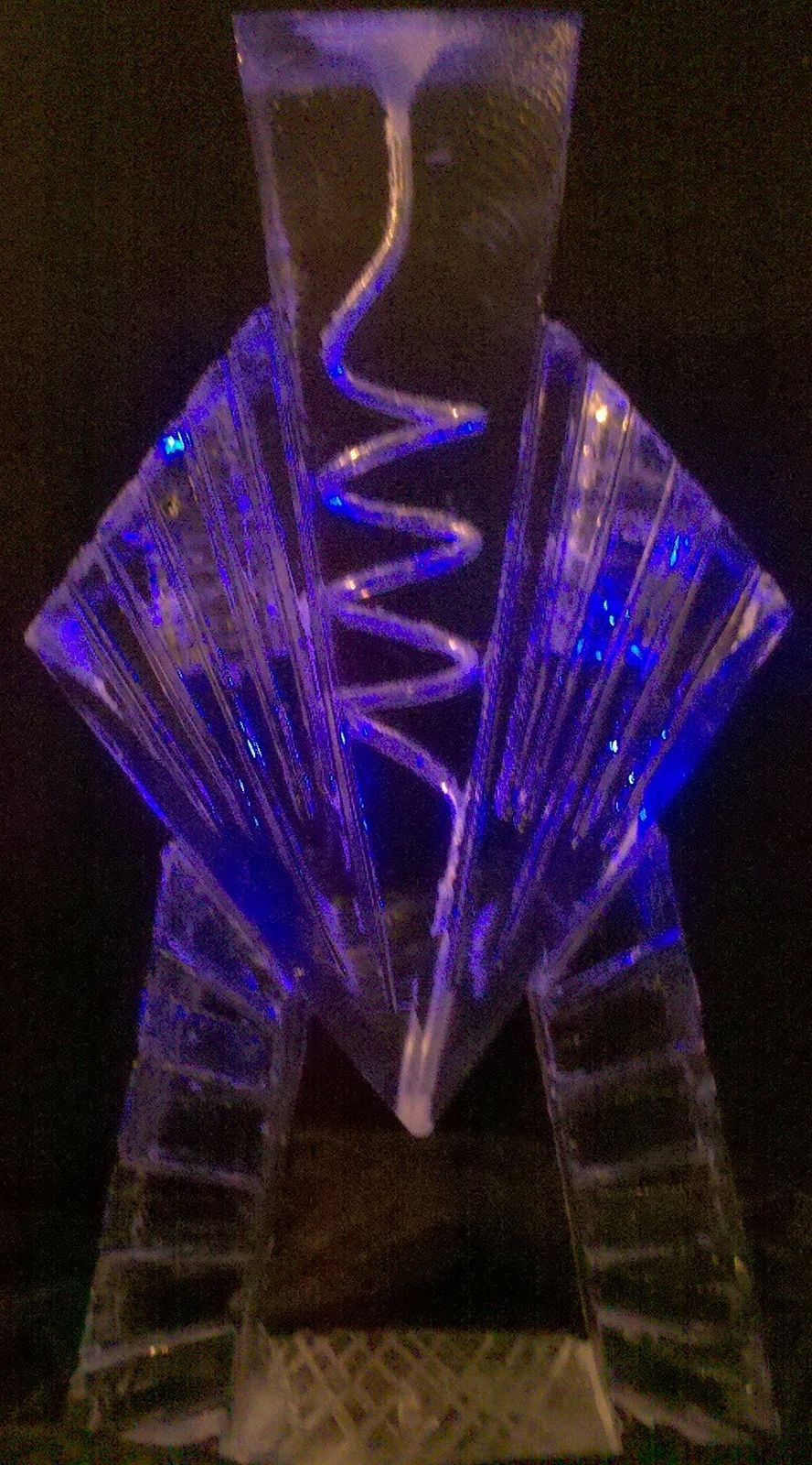 A close up of a glass sculpture with blue lights on it.