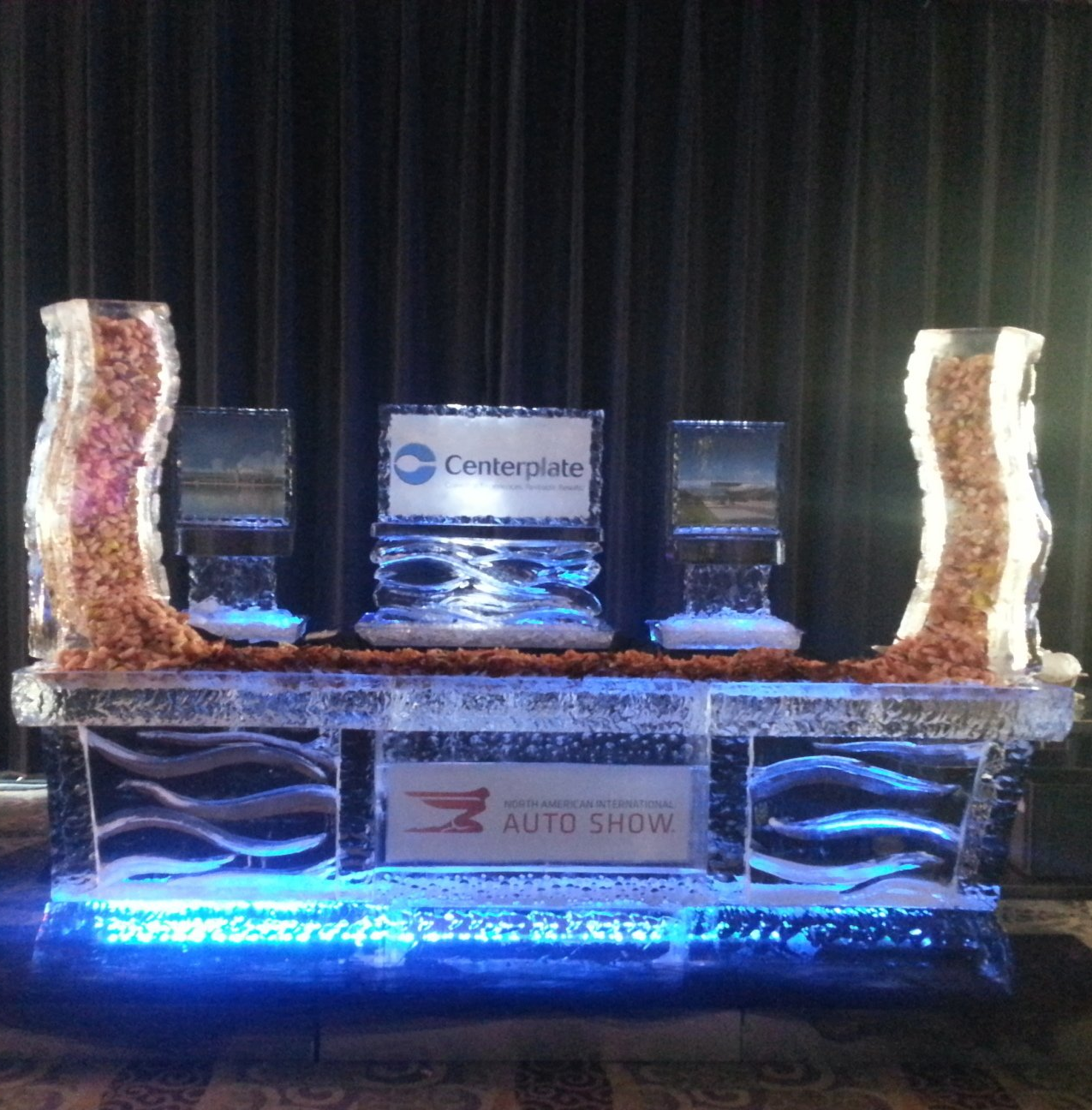 A table with ice sculptures and a centerplate sign