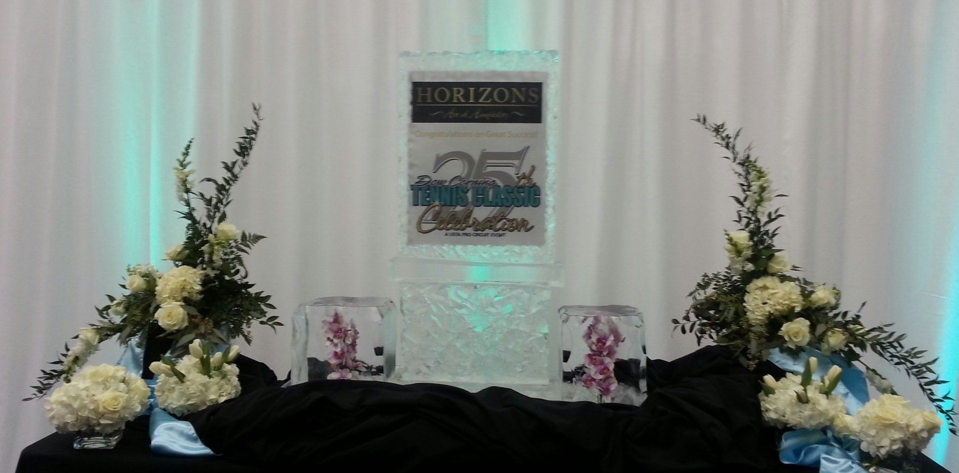 A table with flowers and a sign that says horizons