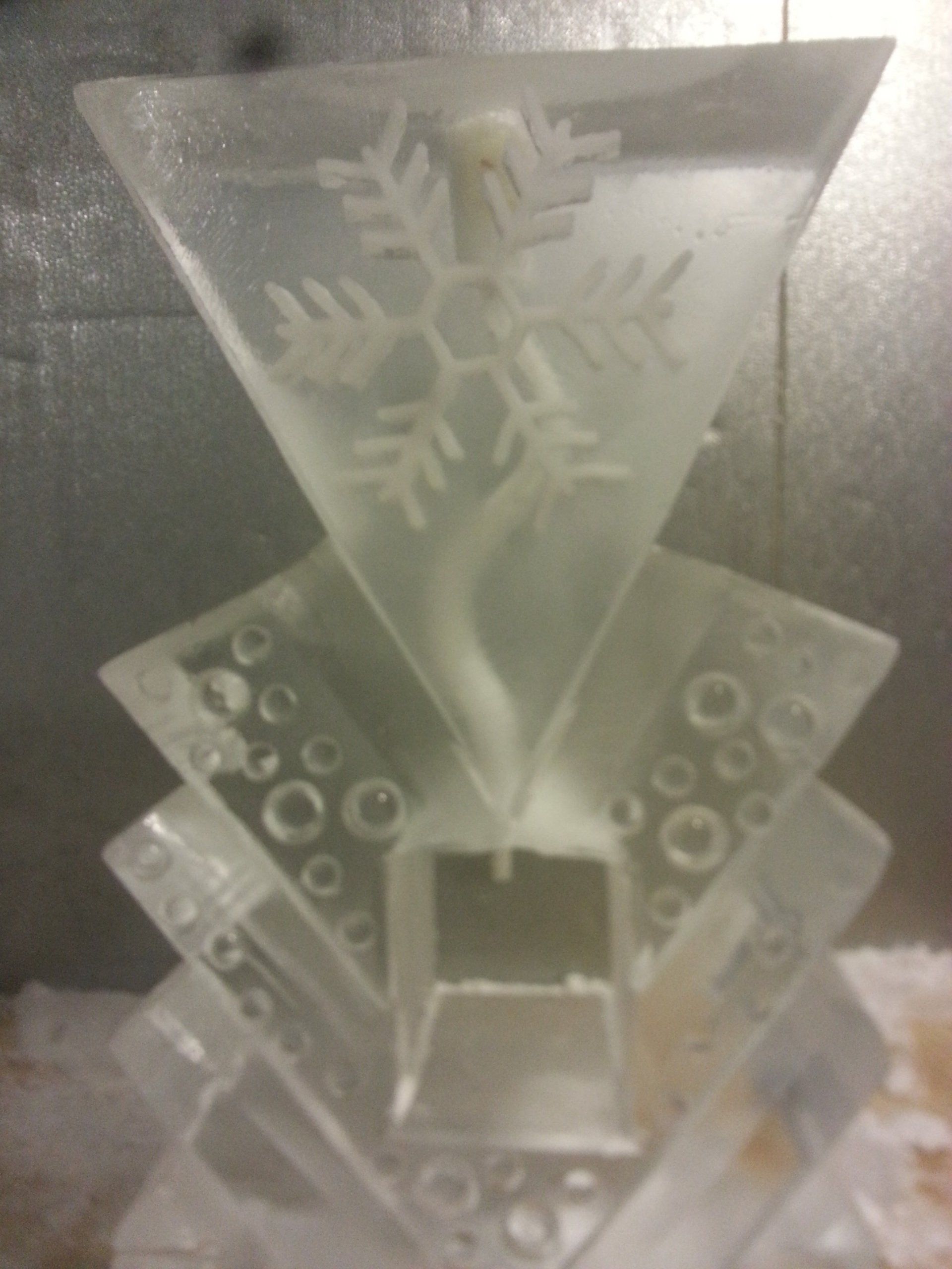 A triangle with a snowflake on it is sitting on a table.