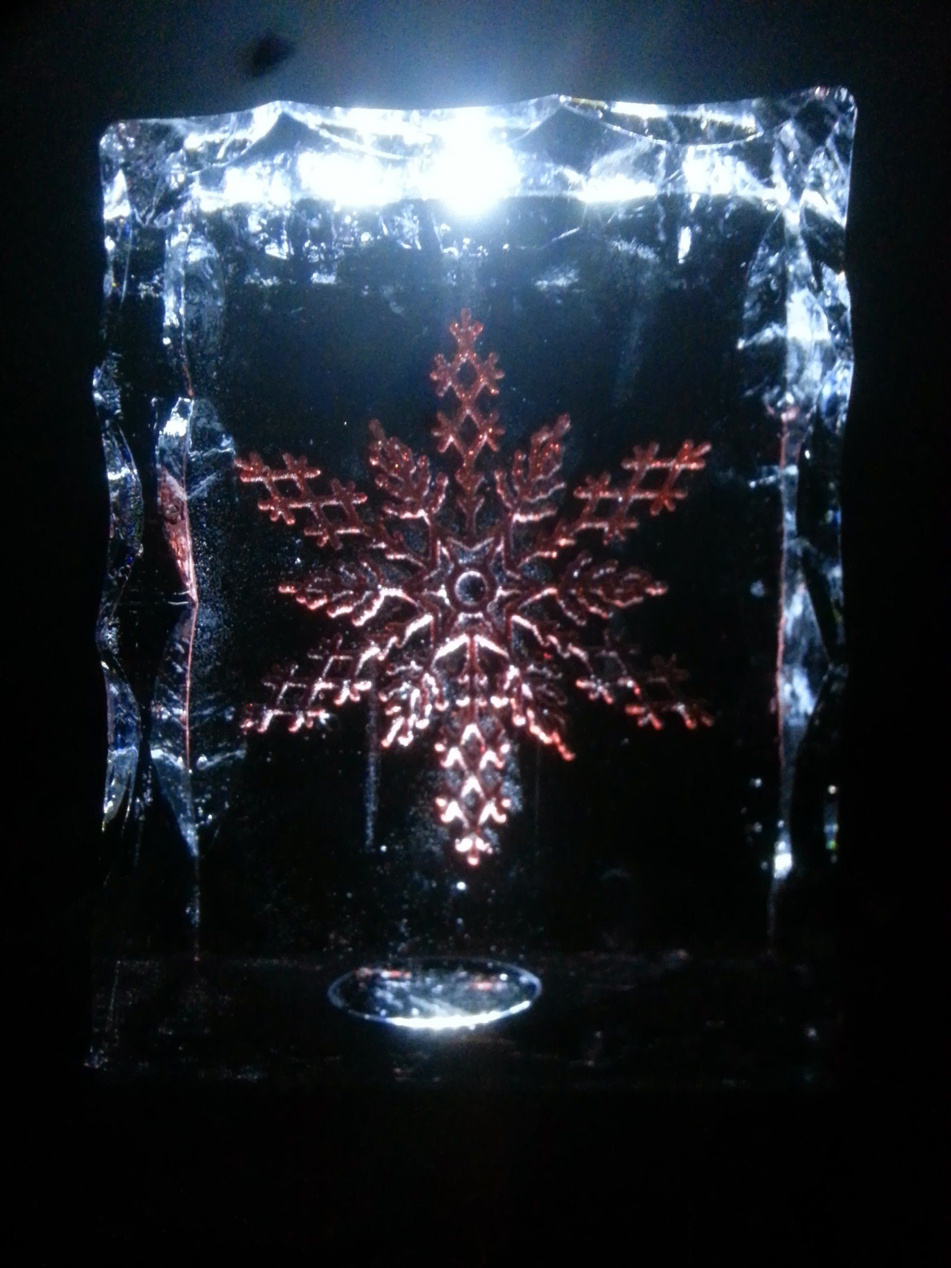 A snowflake is carved into a block of ice