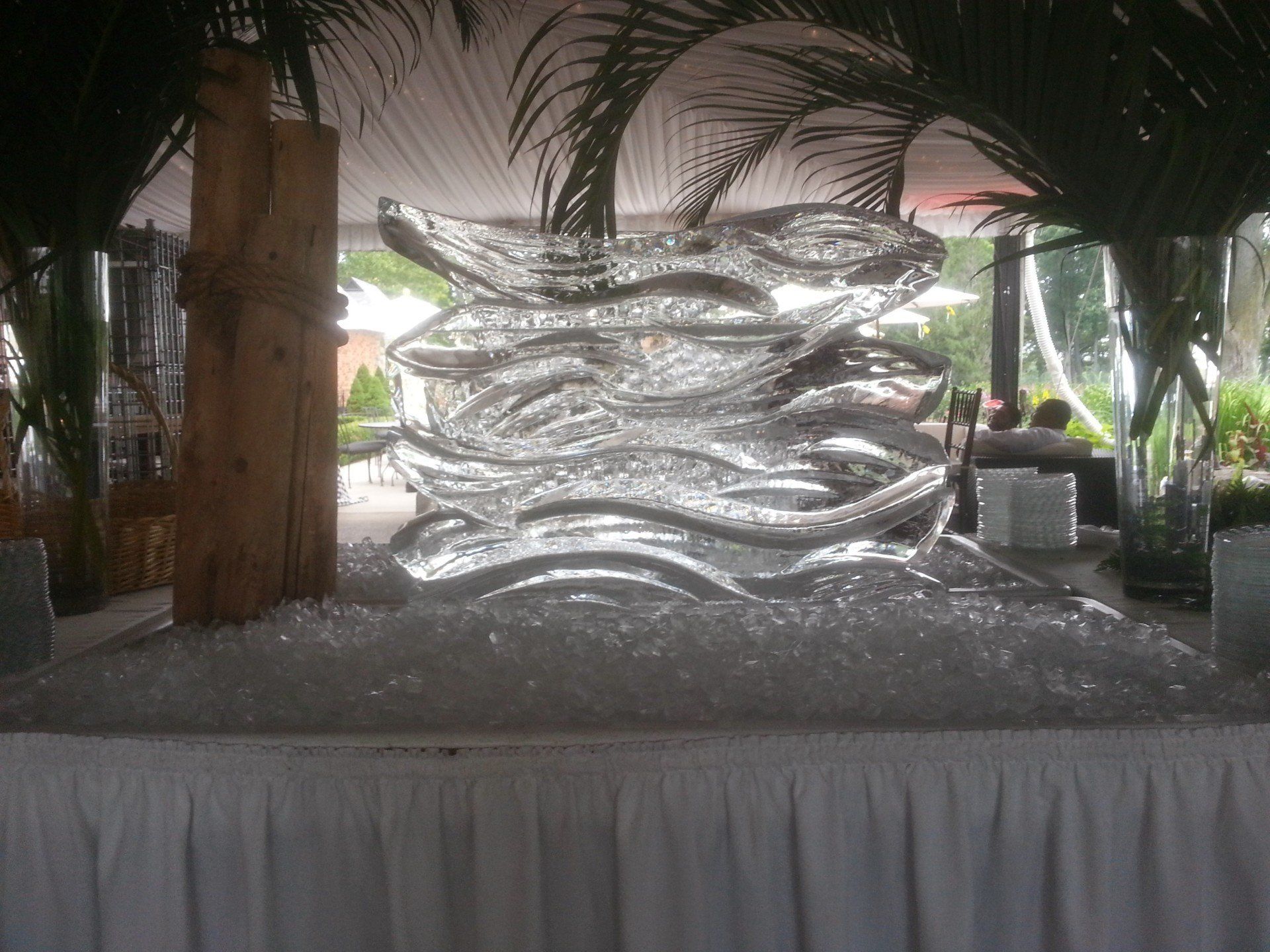A large ice sculpture is sitting on top of a pile of ice.