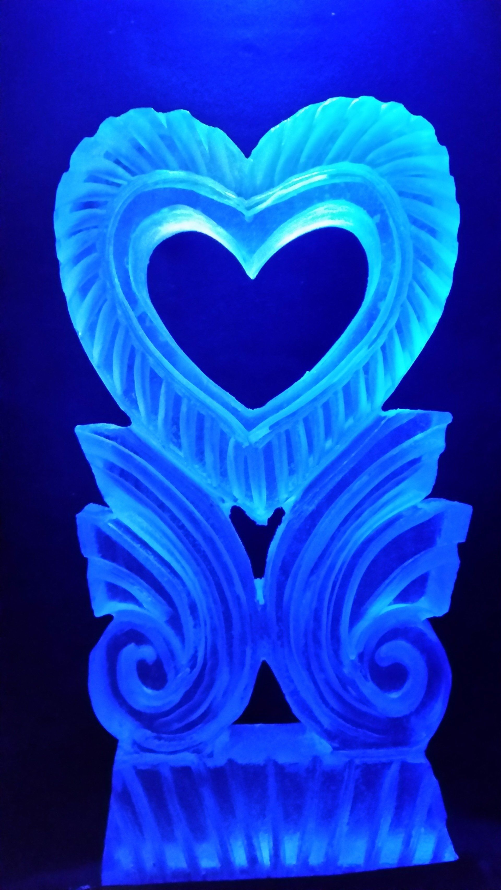 A heart shaped sculpture with a blue light inside of it.