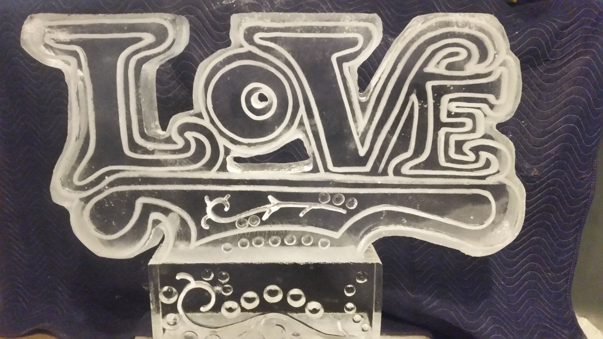 A clear block with the word love on it