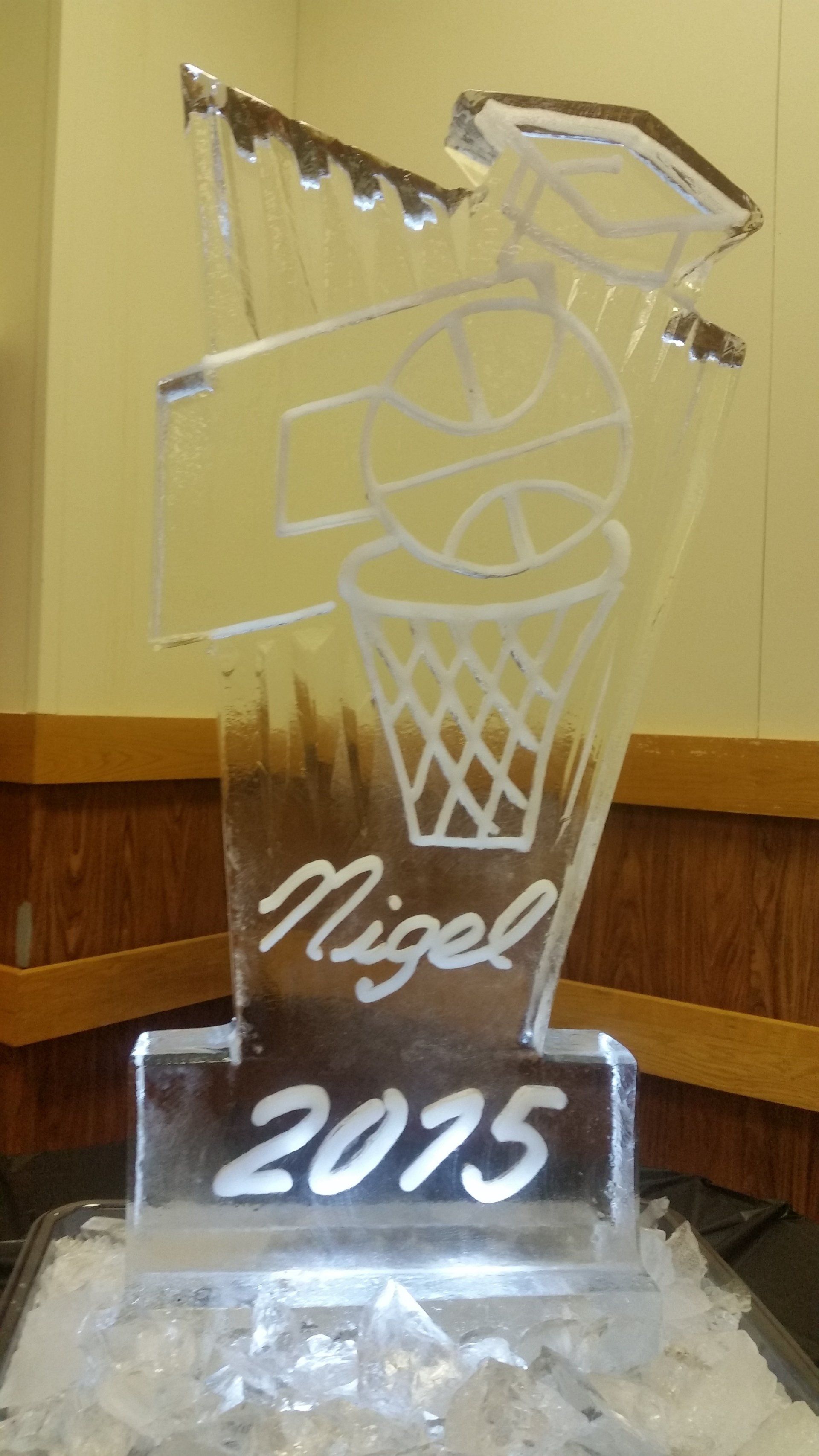 A clear ice sculpture of a basketball hoop with the year 2075 on it.