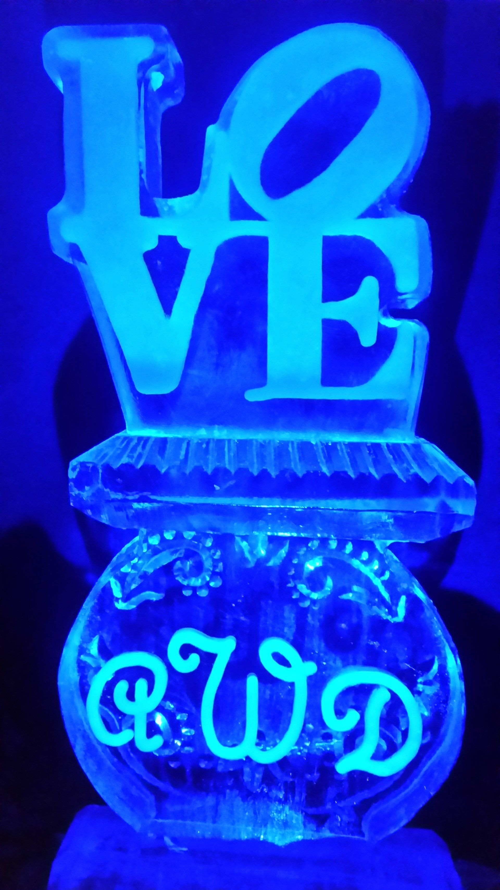 A glow in the dark ice sculpture of the word love