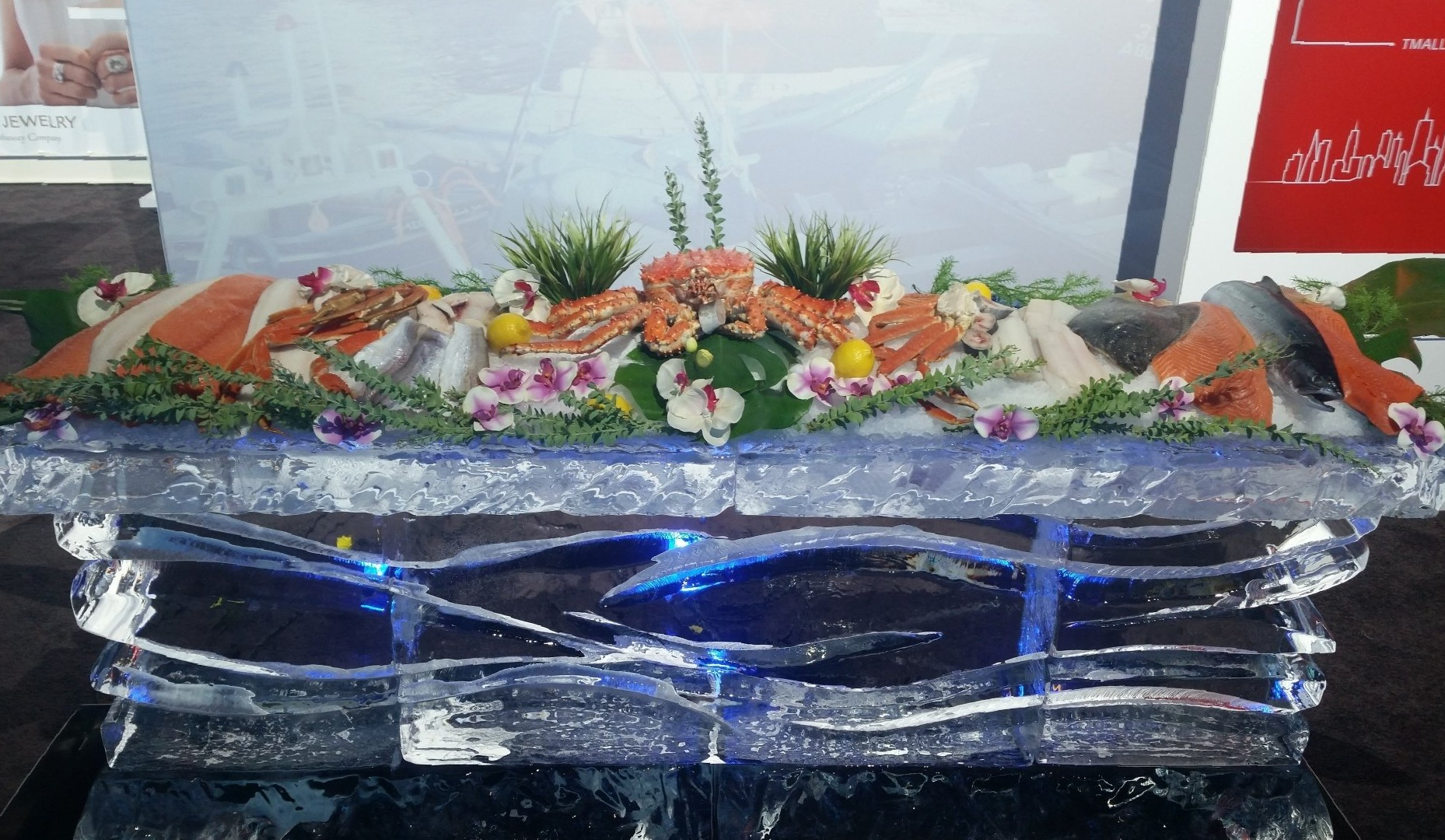 A large ice sculpture filled with shrimp and flowers