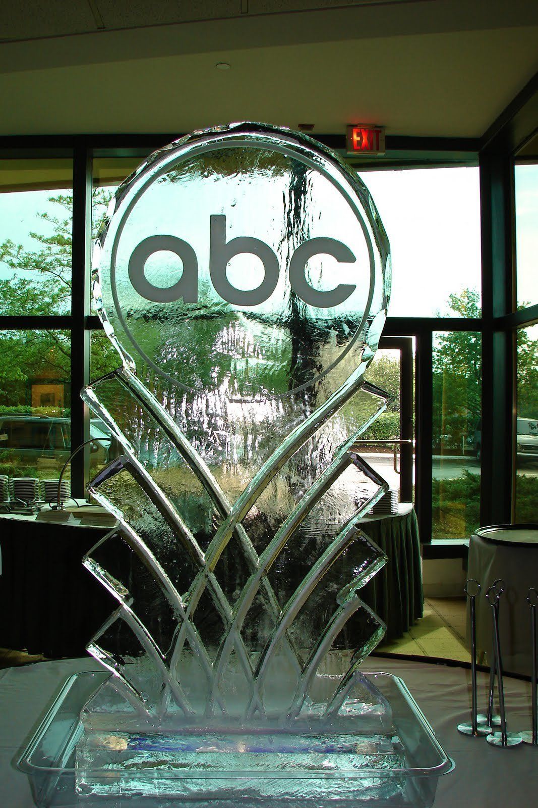 An ice sculpture of the abc logo is sitting on a table.