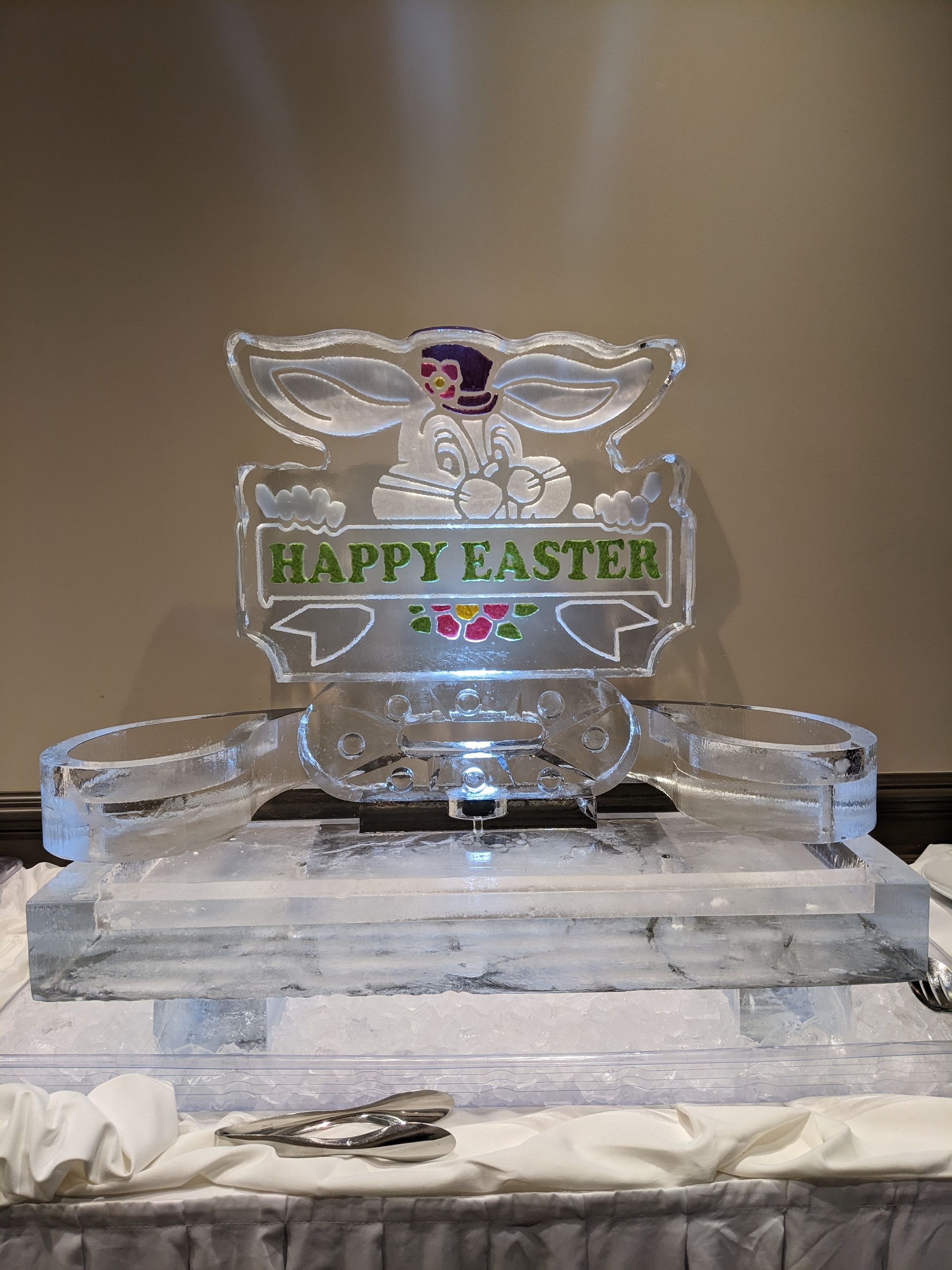 A happy easter ice sculpture is sitting on a table
