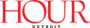 The logo for hour detroit is red and black on a white background.