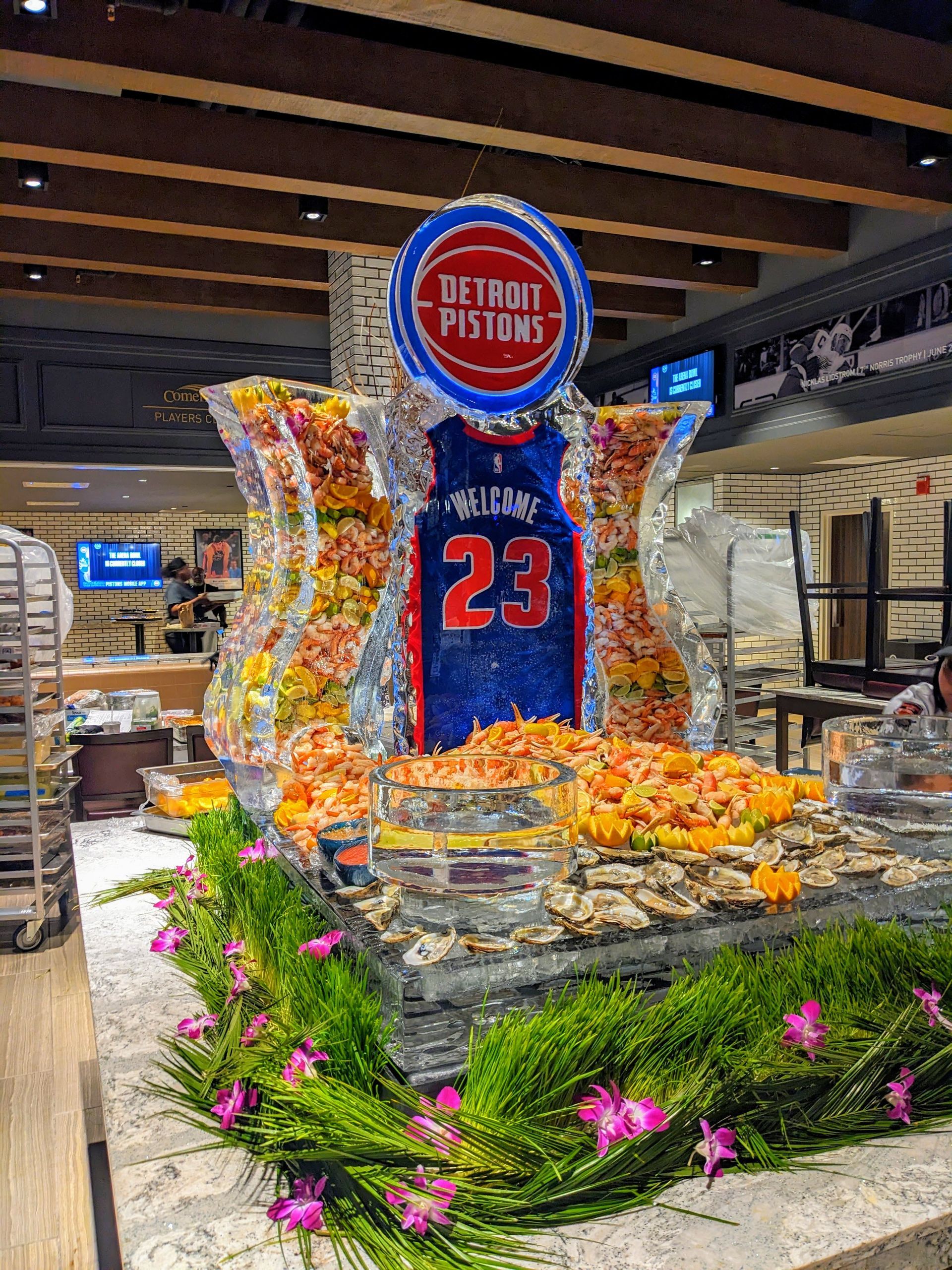 A basketball player 's jersey is on a ice sculpture in a restaurant.
