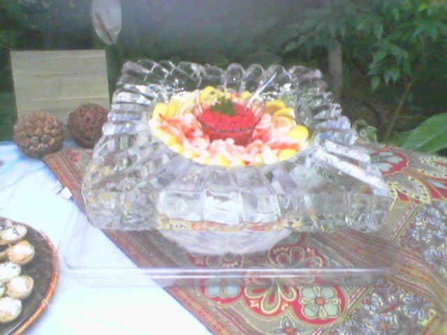 A glass bowl with a strawberry in it on a table