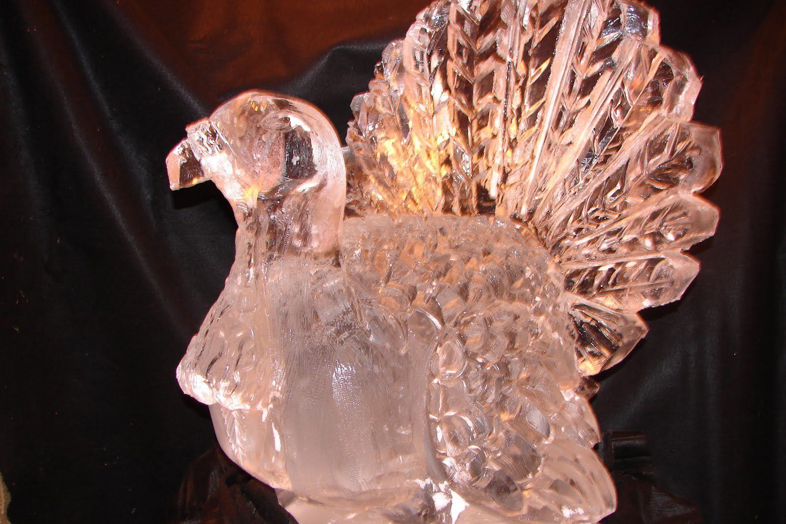 A turkey made of ice is sitting on a table.